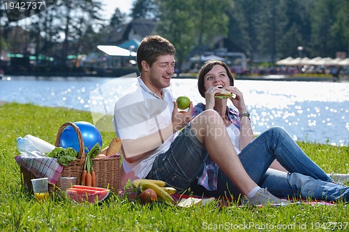 Image of happy young couple having a picnic outdoor