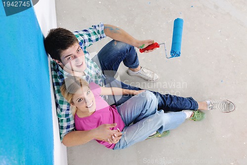 Image of happy young cople relaxing after painting in new home