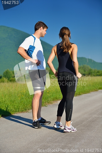 Image of Young couple jogging at morning