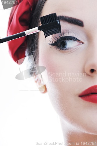 Image of beautiful young woman applying makeup