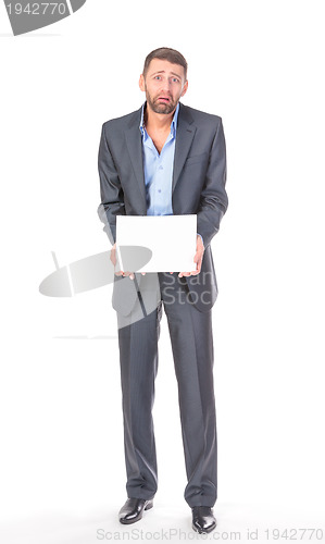 Image of Full length portrait businessman showing an empty board to write