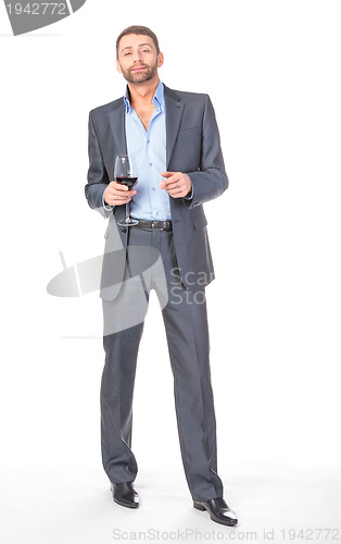 Image of Full length portrait of cheerful business man with glass wine