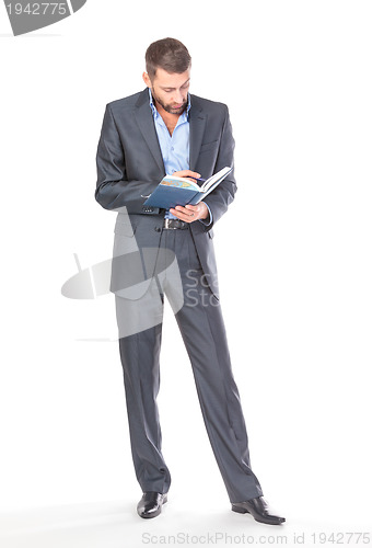 Image of Full length portrait of thoughtful business man with diary