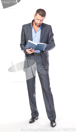 Image of Full length portrait of thoughtful business man with diary