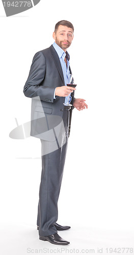 Image of Full length portrait of cheerful business man with glass wine