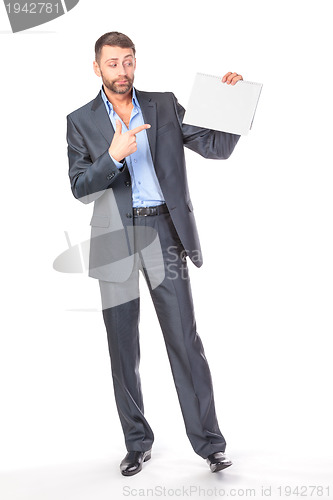Image of Full length portrait businessman showing an empty board to write