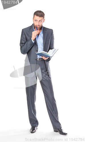 Image of Full length portrait of thoughtful business man with diary