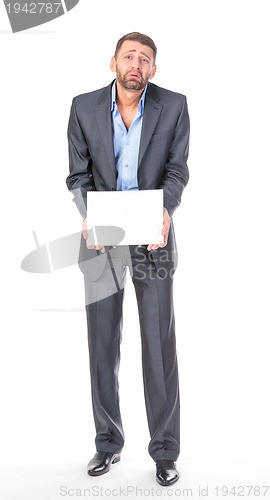Image of Full length portrait businessman showing an empty board to write