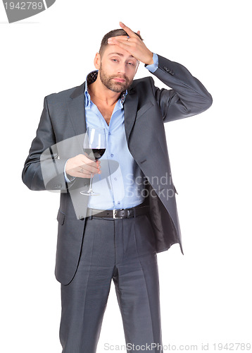 Image of Portrait of thoughtful business man with glass wine