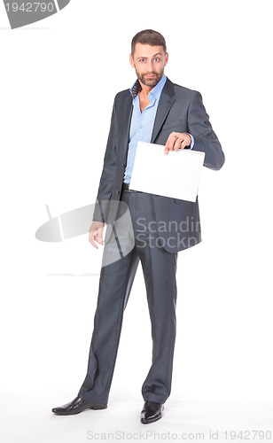 Image of Full length portrait businessman showing an empty board to write