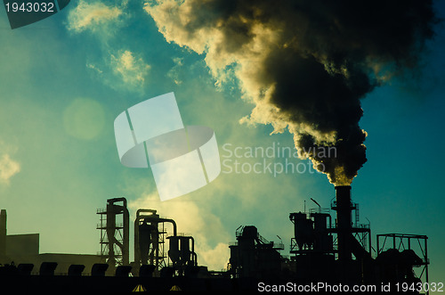 Image of Smoking chimney  at sunset 