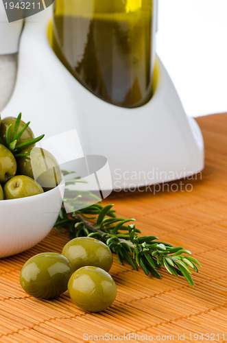 Image of Green olives in a white ceramic bowl