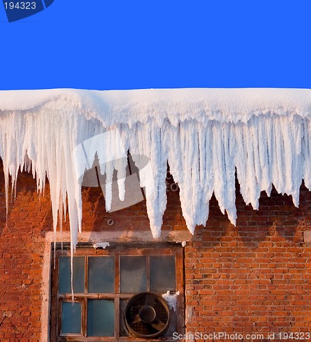 Image of Snow cover on roof of old textile fabric with icicles, deep blue