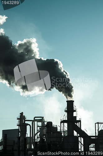 Image of Smoking chimney  at sunset 