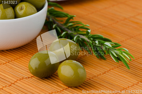 Image of Green olives in a white ceramic bowl