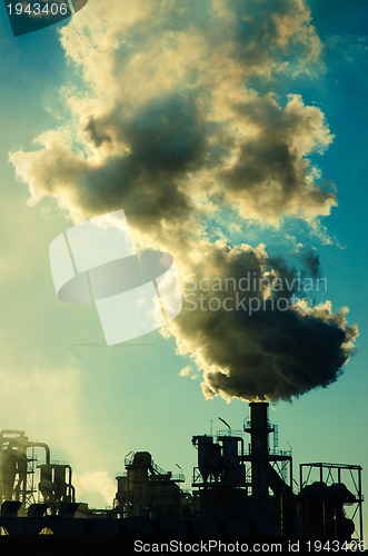 Image of Smoking chimney  at sunset 