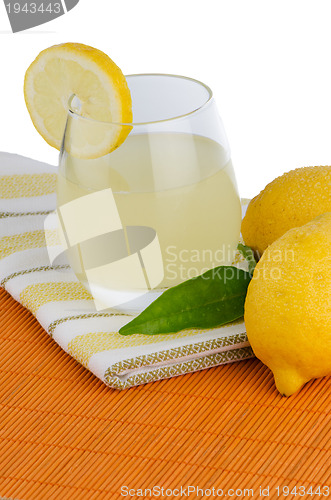 Image of Cup of lemon juice and fresh lemons