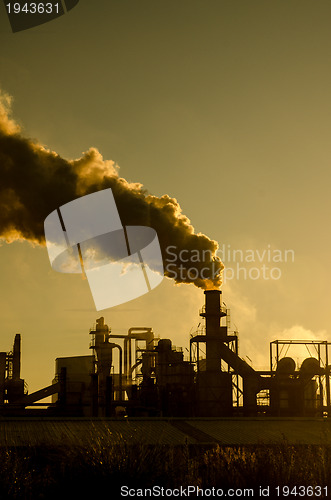 Image of Smoking chimney  at sunset 