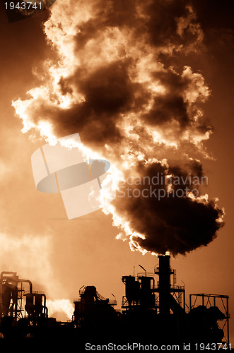 Image of Smoking chimney  at sunset 