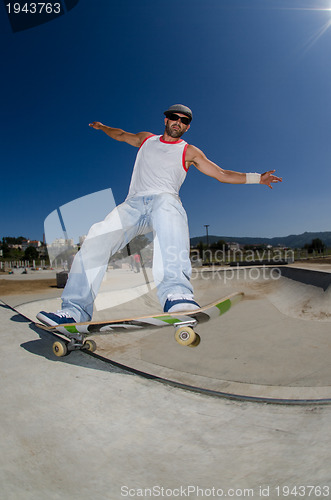 Image of Skateboarder in a concrete pool 