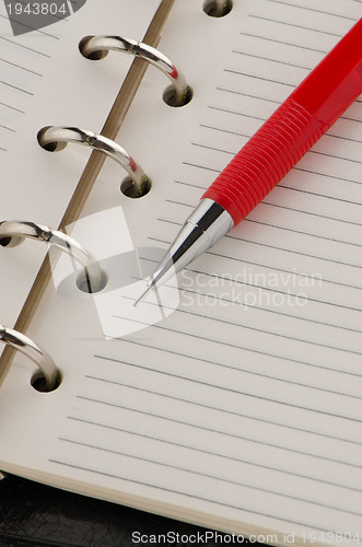 Image of Note book and pencil