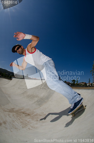 Image of Skateboarder in a concrete pool 