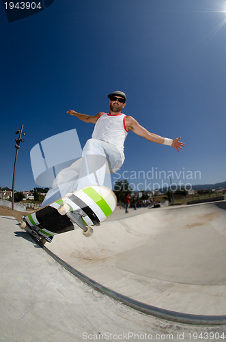 Image of Skateboarder in a concrete pool 