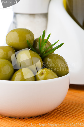 Image of Green olives in a white ceramic bowl