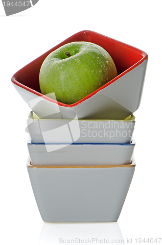Image of Colorful bowls with green apple