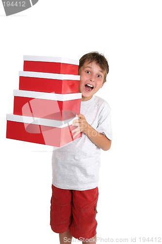 Image of Excited child carrying gift boxes