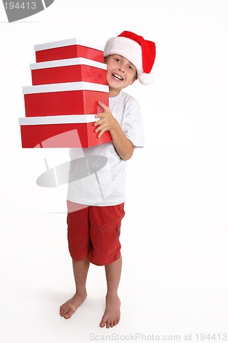 Image of Child holding a stack of gift boxes