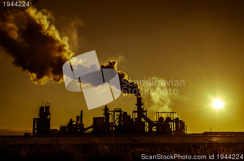 Image of Smoking chimney  at sunset 
