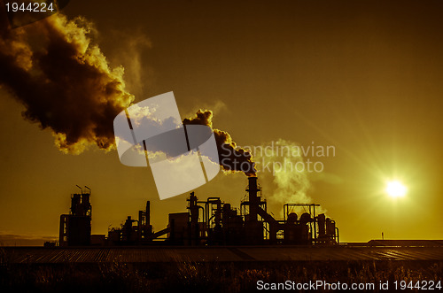 Image of Smoking chimney  at sunset 