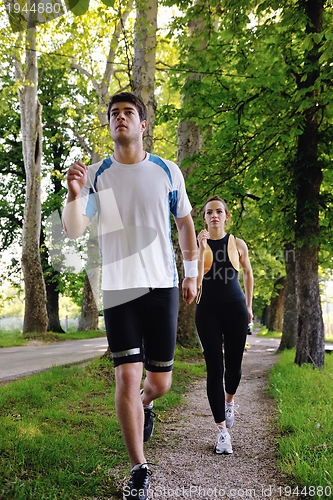 Image of Young couple jogging