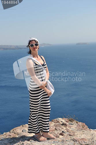 Image of Greek woman on the streets of Oia, Santorini, Greece