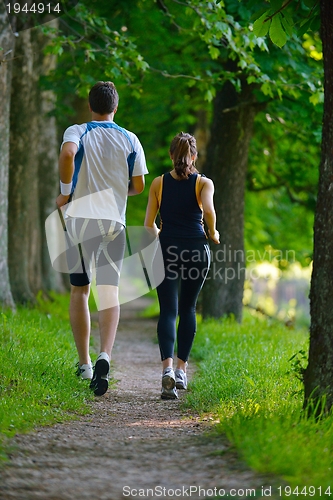 Image of Young couple jogging