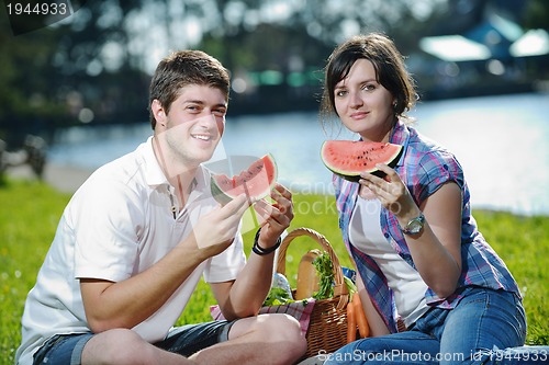 Image of happy young couple having a picnic outdoor