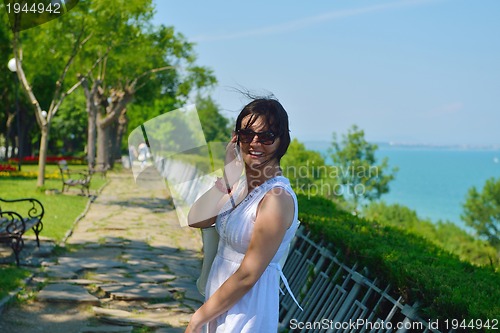 Image of young business woman using mobile phone outdoor