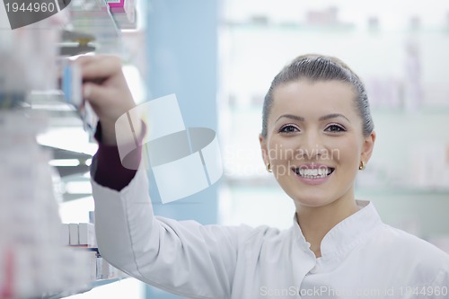 Image of pharmacist chemist woman standing in pharmacy drugstore