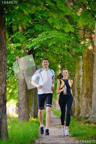 Image of Young couple jogging