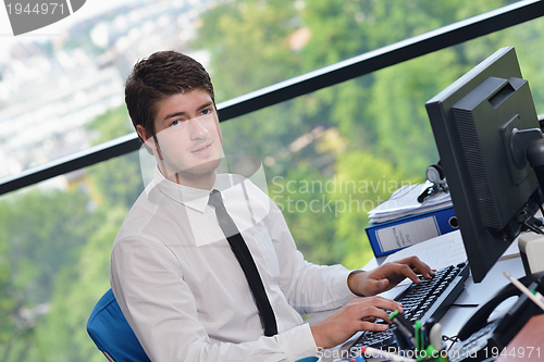 Image of happy young business man at office