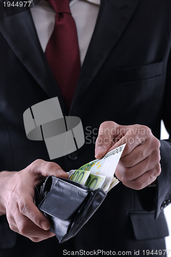 Image of Business man holding money