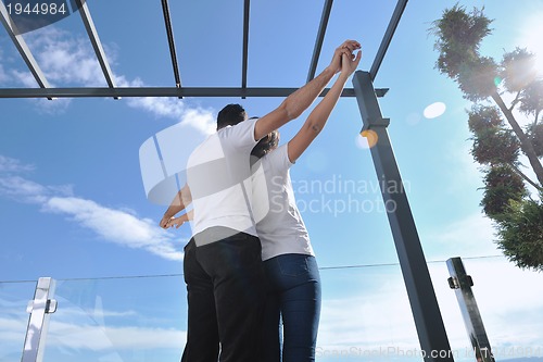 Image of couple relaxing on balcony