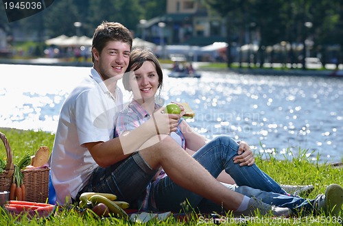 Image of happy young couple having a picnic outdoor