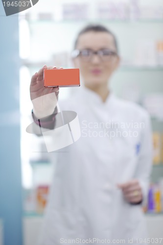 Image of pharmacist chemist woman standing in pharmacy drugstore