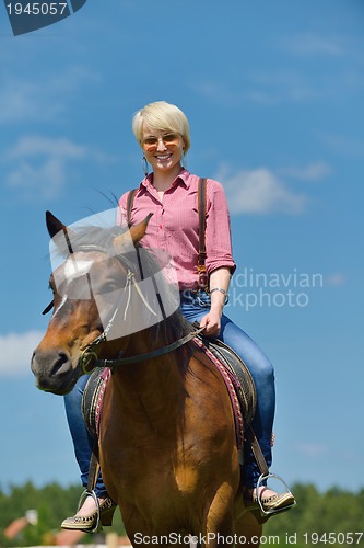 Image of happy woman  ride  horse