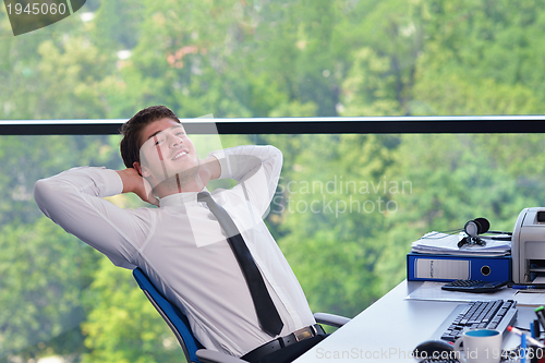 Image of happy young business man at office