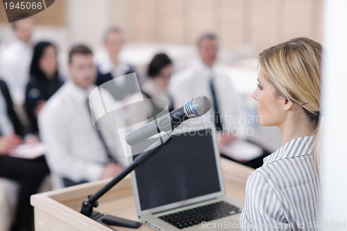 Image of business woman standing with her staff at conference