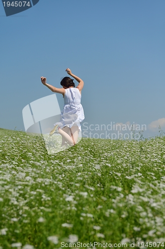 Image of Young happy woman in green field