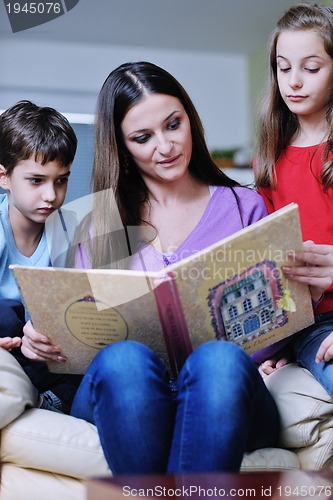 Image of young mom play with their kids at home and reading book
